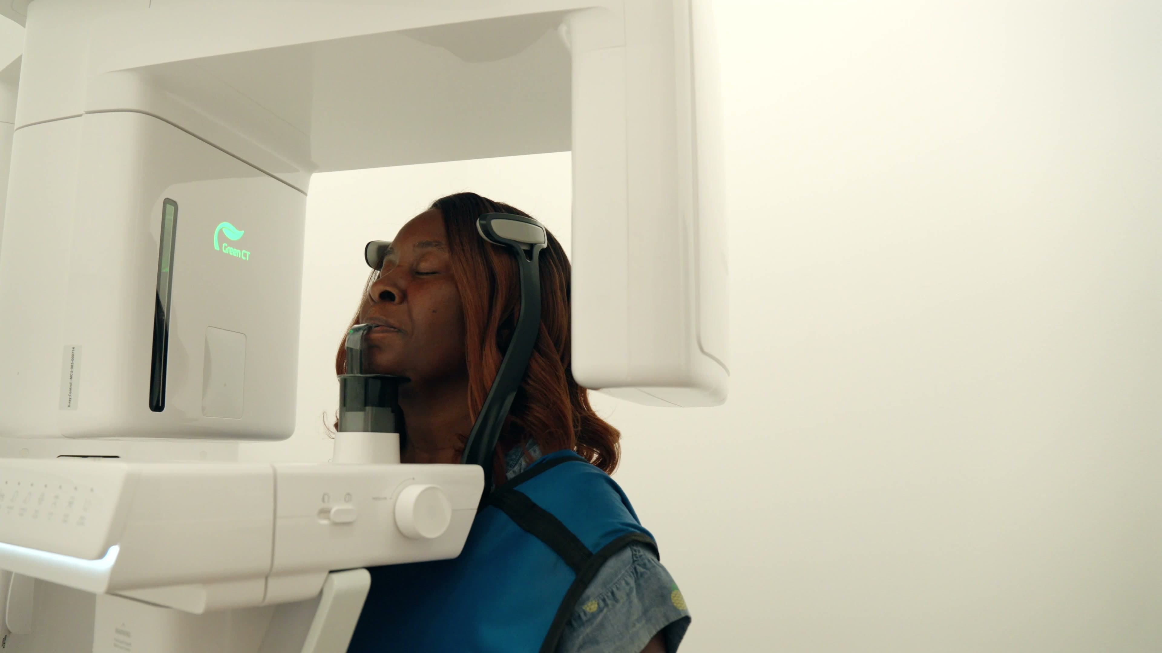 A patient being positioned in the panoramic imaging unit