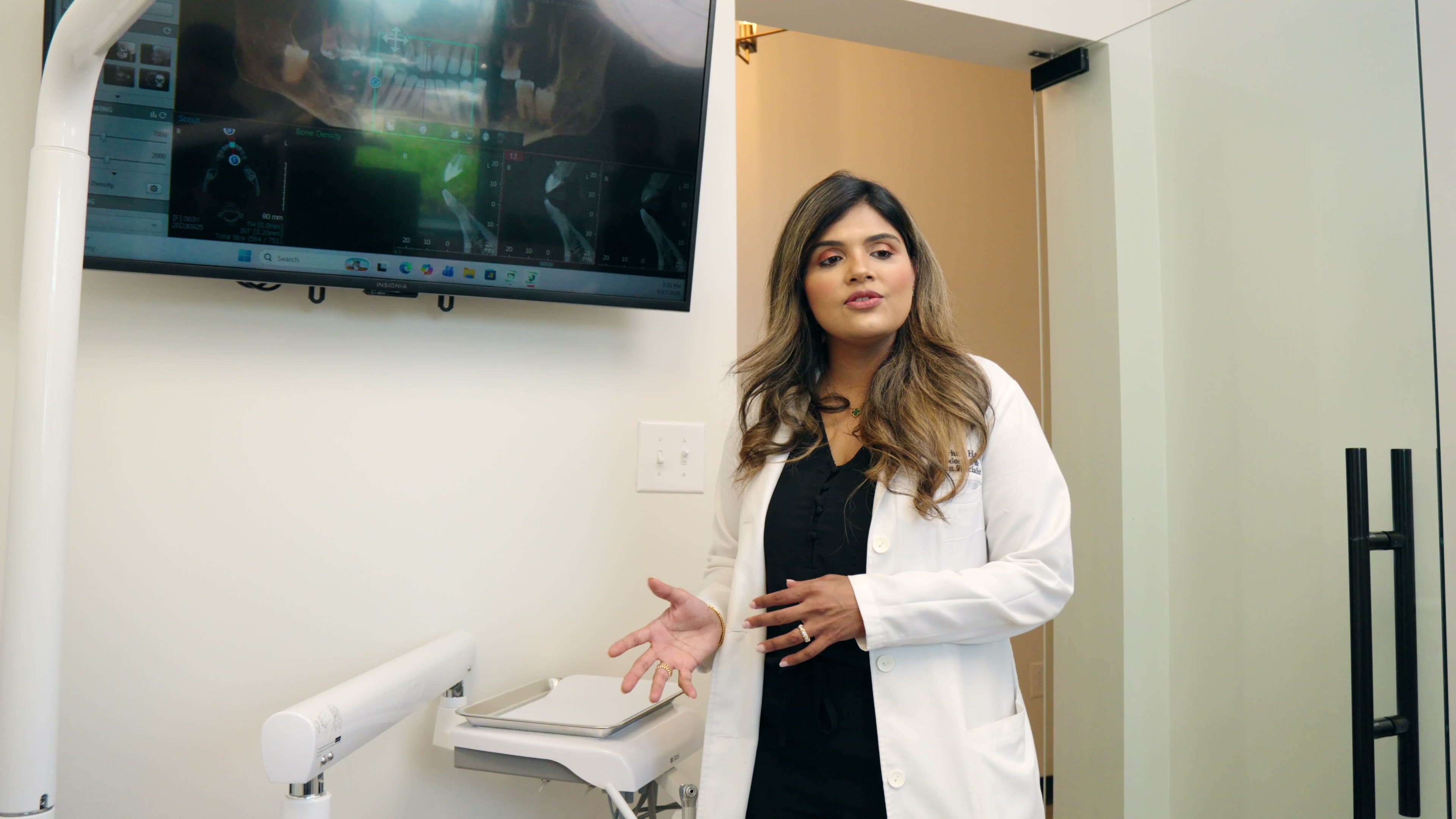 A FixDental dentist reviewing a panoramic scan on the operatory screen